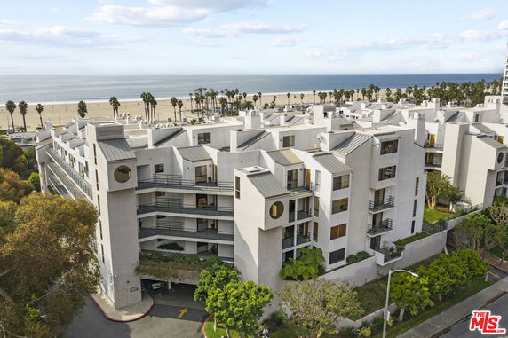 View of a residential building complex near a beach.
