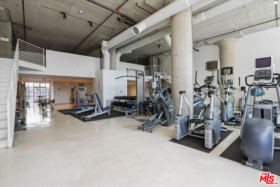 Interior view of a gym area with exercise equipment and fitness machines.