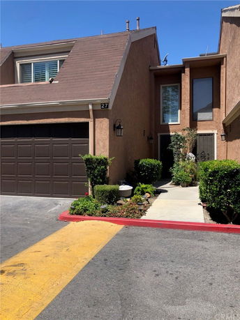 Front view of a house with a garage and an entrance pathway.