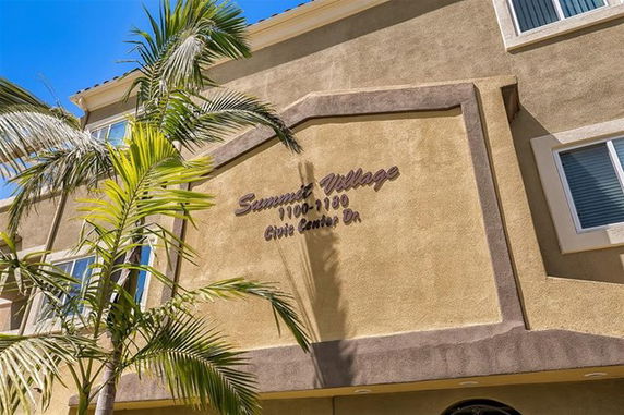 Front view of a multi-story building with signage.