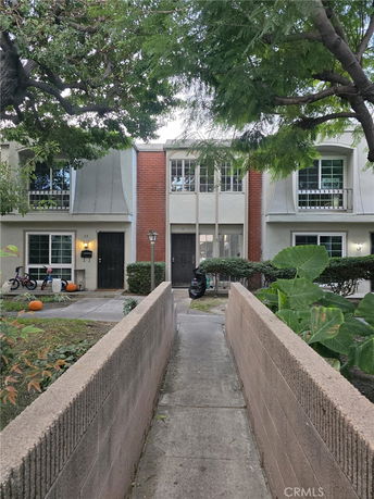 Front view of a two-story house with brick and white exterior.