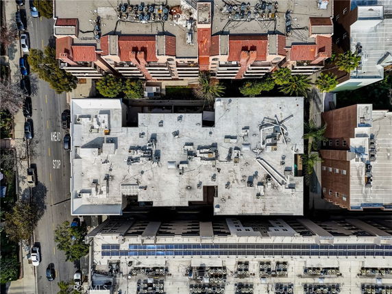 Aerial view of a building rooftop with multiple structures and machinery.