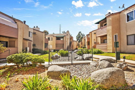 View of apartment buildings with balconies and landscaped surroundings