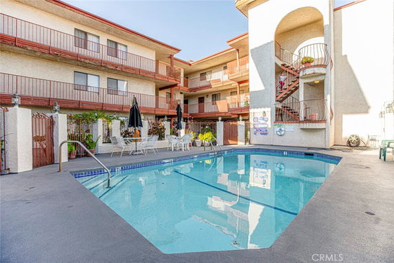 Outdoor view of a building with a swimming pool area.