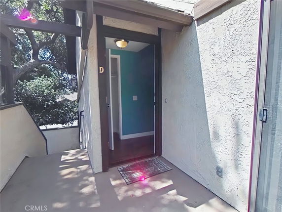 Front entrance of a building with stairs and a small landing.