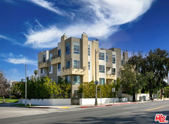 Front view of a multi-story modern building with balconies.