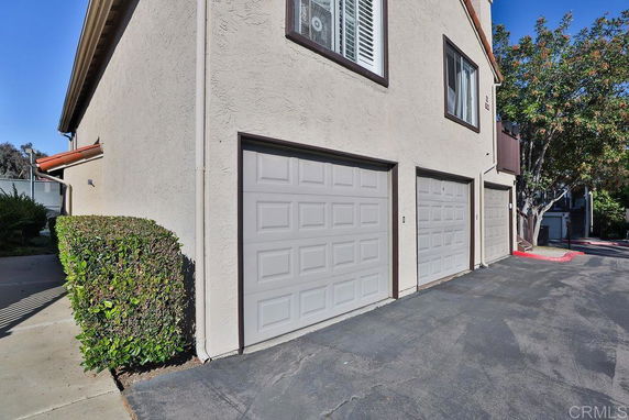 Side view of a residential building with three garage doors.