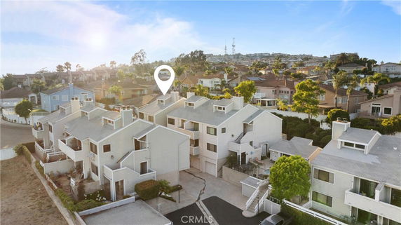 Aerial view of a complex with attached multi-story houses in a residential area.