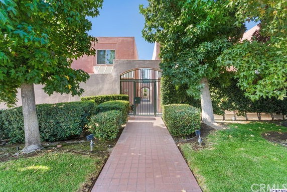 Front view of a house with a gated entrance pathway.
