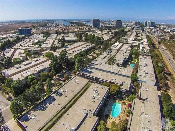 Panoramic view of a residential area with multiple buildings and a swimming pool.