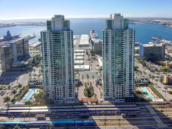 View of two high-rise towers near a waterfront area.
