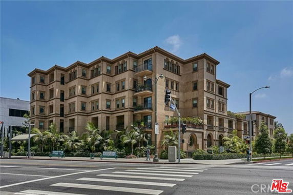 Front view of a multi-story residential building at an intersection.