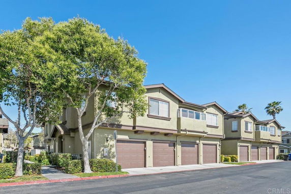 Front view of a multi-story residential complex with attached garages.