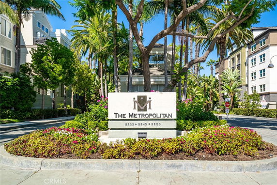 Front view of multi-story residential buildings with a central sign reading 'The Metropolitan'.