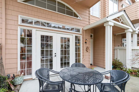 Front view of a house with a glass door entrance and small porch.