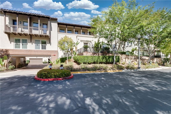 Front view of a multi-story residential building with balconies.
