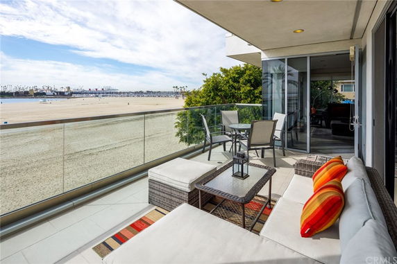 Balcony view overlooking a sandy beach and ocean.