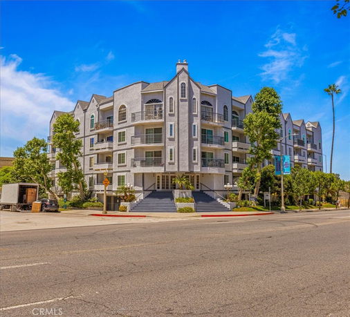 Front view of a multi-story residential building with balconies.