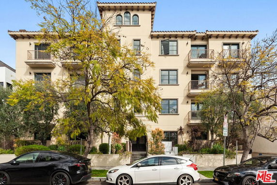 Front view of a multi-story residential building with balconies.