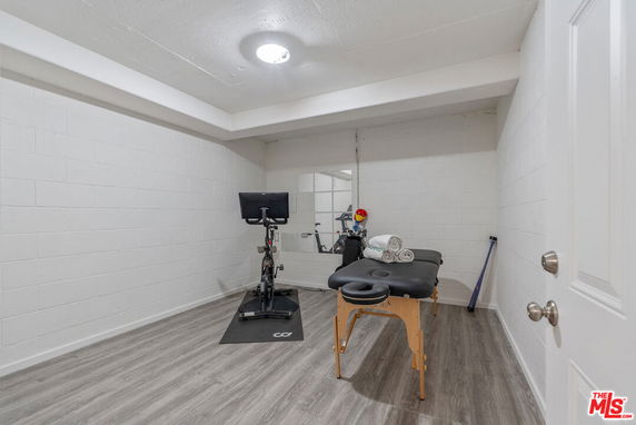 Room with exercise equipment and massage table