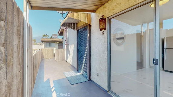 Rooftop area with railing and sliding glass door.