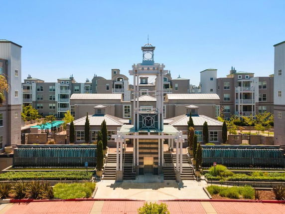 Front view of a large, multi-story residential complex with modern architectural design.
