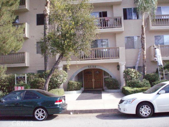 Front view of a multi-story apartment building with balconies.