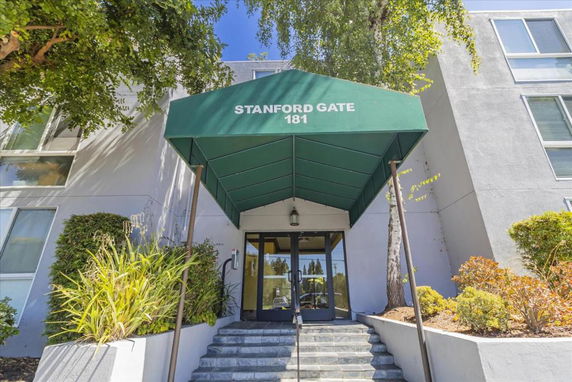 Front view of a building entrance with a green canopy labeled 'Stanford Gate 181'.