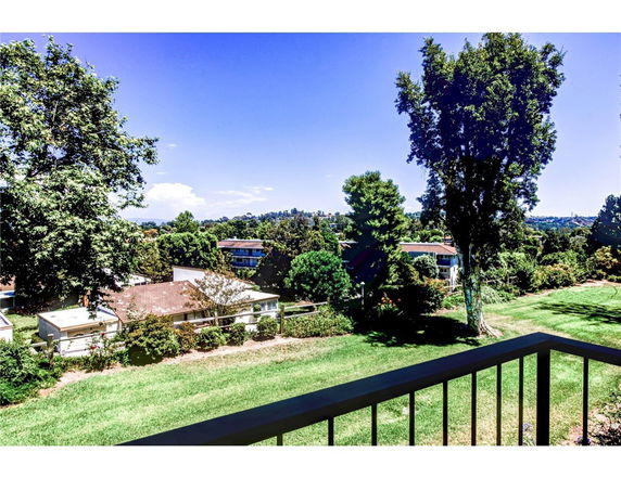 Panoramic view of buildings surrounded by trees and grassy areas.