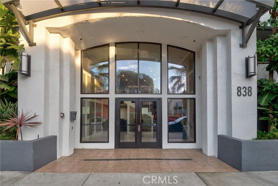 Front view of a building entrance with large glass doors and windows.