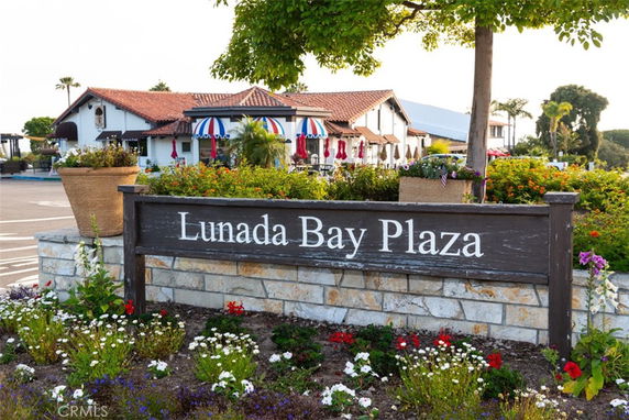 Front view of a building with a red tiled roof and outdoor seating area.
