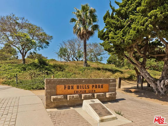 Entrance sign for Fox Hills Park in Culver City, surrounded by trees and greenery.