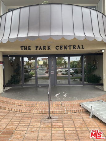 Front view of a building entrance with a sign reading 'The Park Central'.