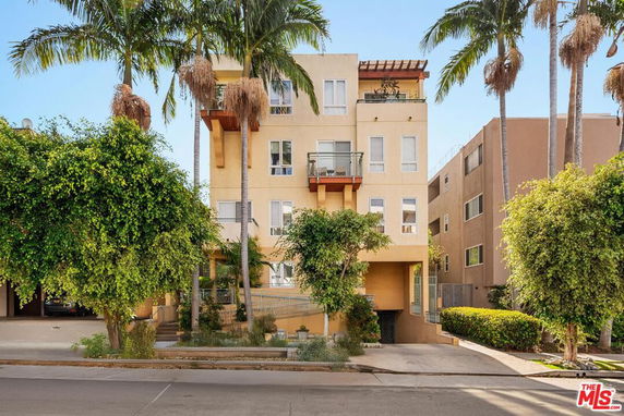 Front view of a multi-story residential building with balconies.