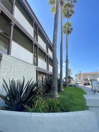 Side view of a multi-story building with balconies.