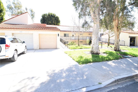 Front view of a single-story house with a double garage and sloped driveway.