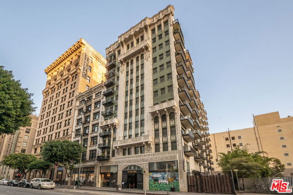 Front view of a multi-story building with balconies.
