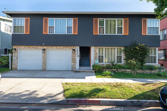 Front view of a two-story building with a double garage.