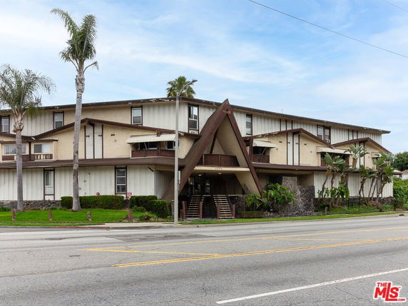 Front view of a multi-story building with a distinctive A-frame entrance.
