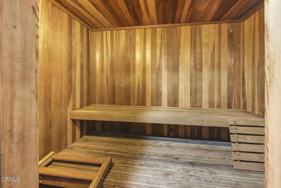 Interior view of a wooden sauna with benches.