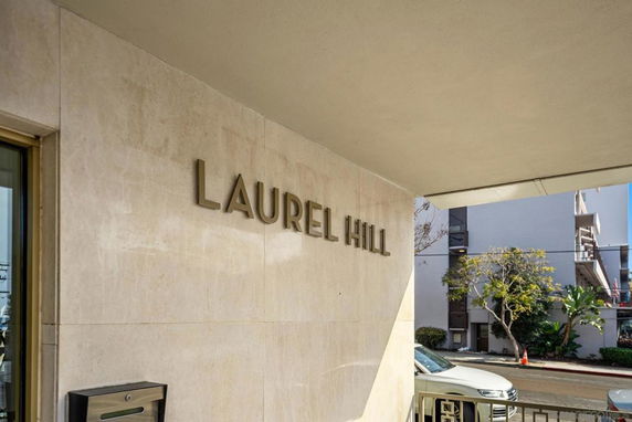 Entrance area of a building with the name 'Laurel Hill' displayed on an exterior wall.