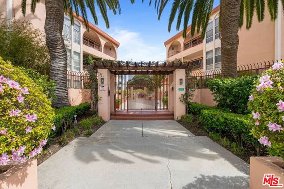 Front view of a multi-story building with gated entrance.