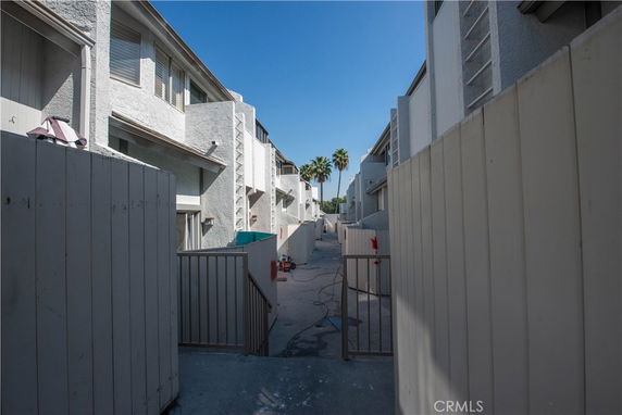 View of apartment buildings with gated entryway.