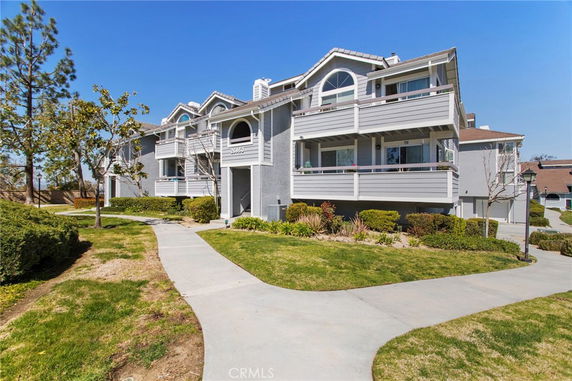 Front view of a multi-story residential building with balconies.