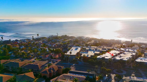 Panoramic view of a coastal residential area with the ocean in the background.