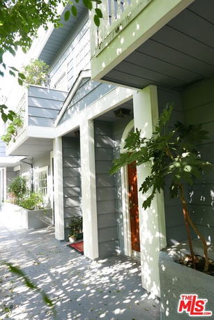 Front view of a two-story house with a balcony.