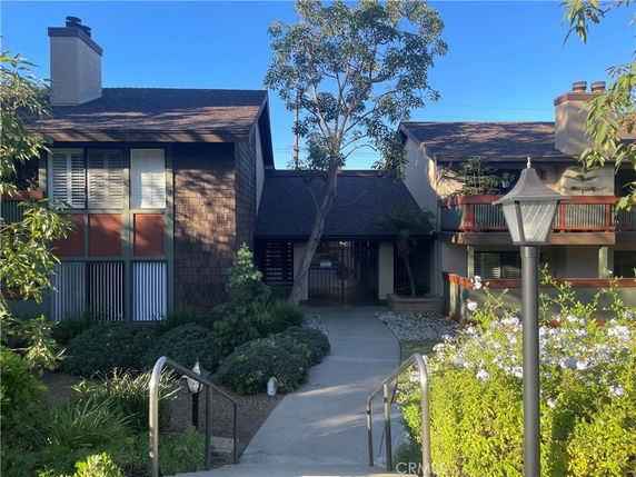 Front view of a residential building with a pathway leading to the entrance.