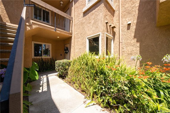 Entrance area of a building with plants and a staircase.