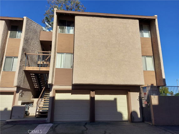Front view of a multi-story residential building with garage.