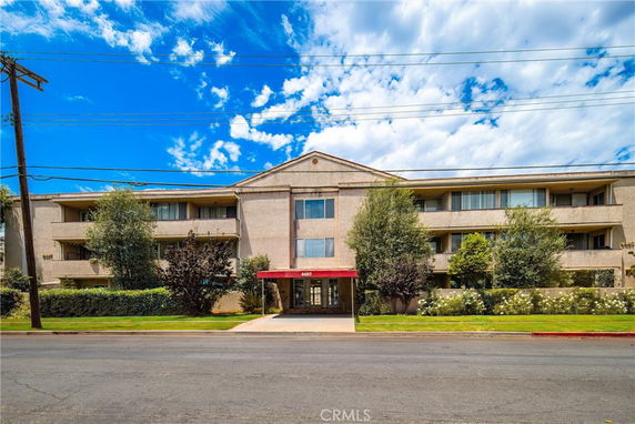 Front view of a multi-story residential building with balconies.